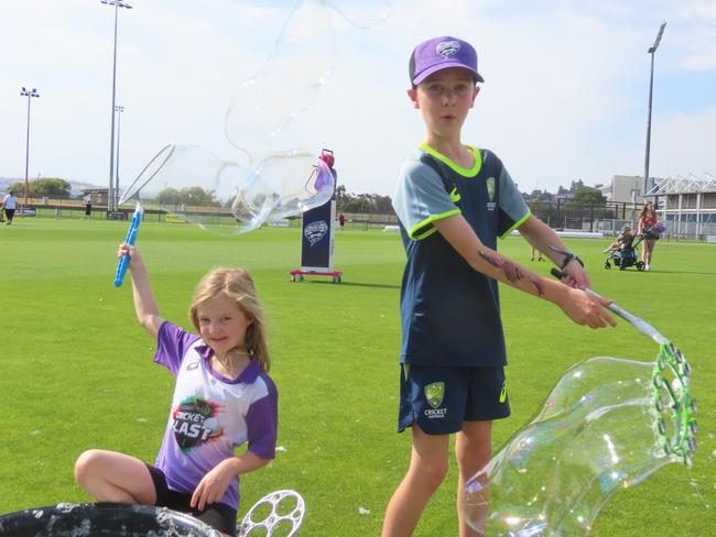 Hurricanes fans Harry and Maddie Swain enjoy making bubbles at Tuesday's fan day in Launceston. Picture: Jon Tuxworth