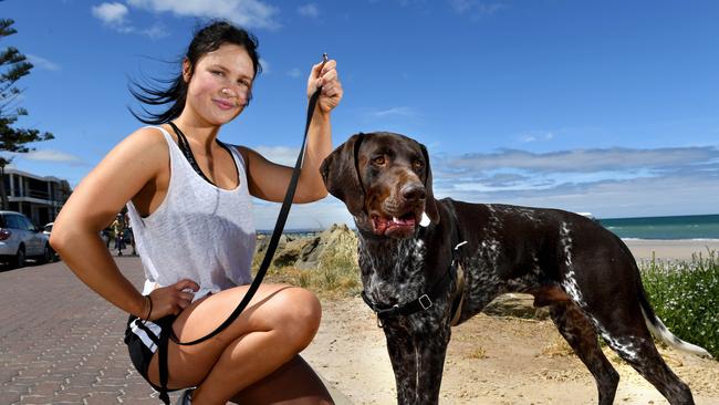 Dog walker Emma Careek with her dog, Otto, on the path at Henley Beach. Picture: Tricia Watkinson