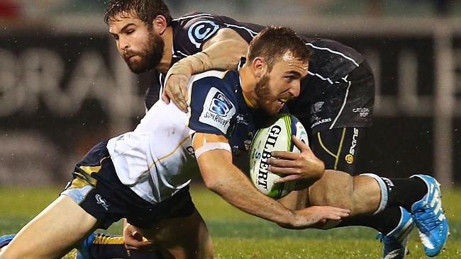 CANBERRA, AUSTRALIA - MAY 10: Nic White of the Brumbies is tackled during the round 13 Super Rugby match between the Brumbies and the Sharks at Canberra Stadium on May 10, 2014 in Canberra, Australia. (Photo by Mark Nolan/Getty Images)