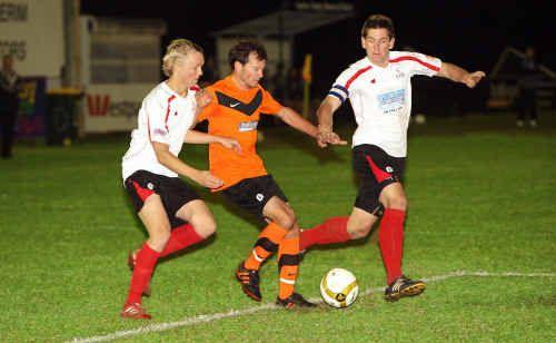 Buderim’s Robbie McDonald runs the ball past Caloundra’s Matthew Cornthwaite, left, and Ray Schultz. Picture: Cade Mooney