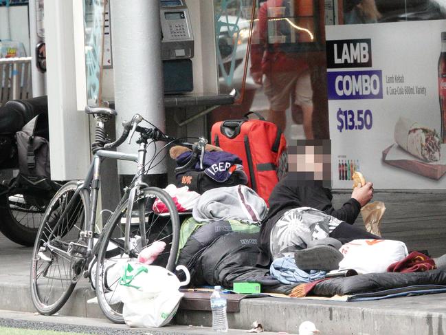 People sleeping rough near the corner of Elizabeth and Flinders streets.