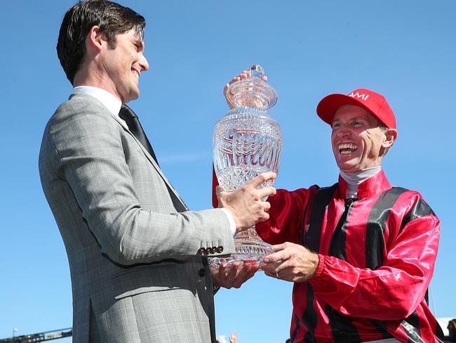 James Cummings and jockey Glyn Schofield share a special moment at the trophy ceremon. Picture: Ian Currie