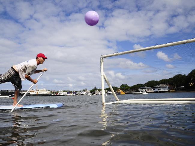 Lance O'Connor playing Stand Up paddle Board Soccer in Rose Bay. Picture: John Appleyard.