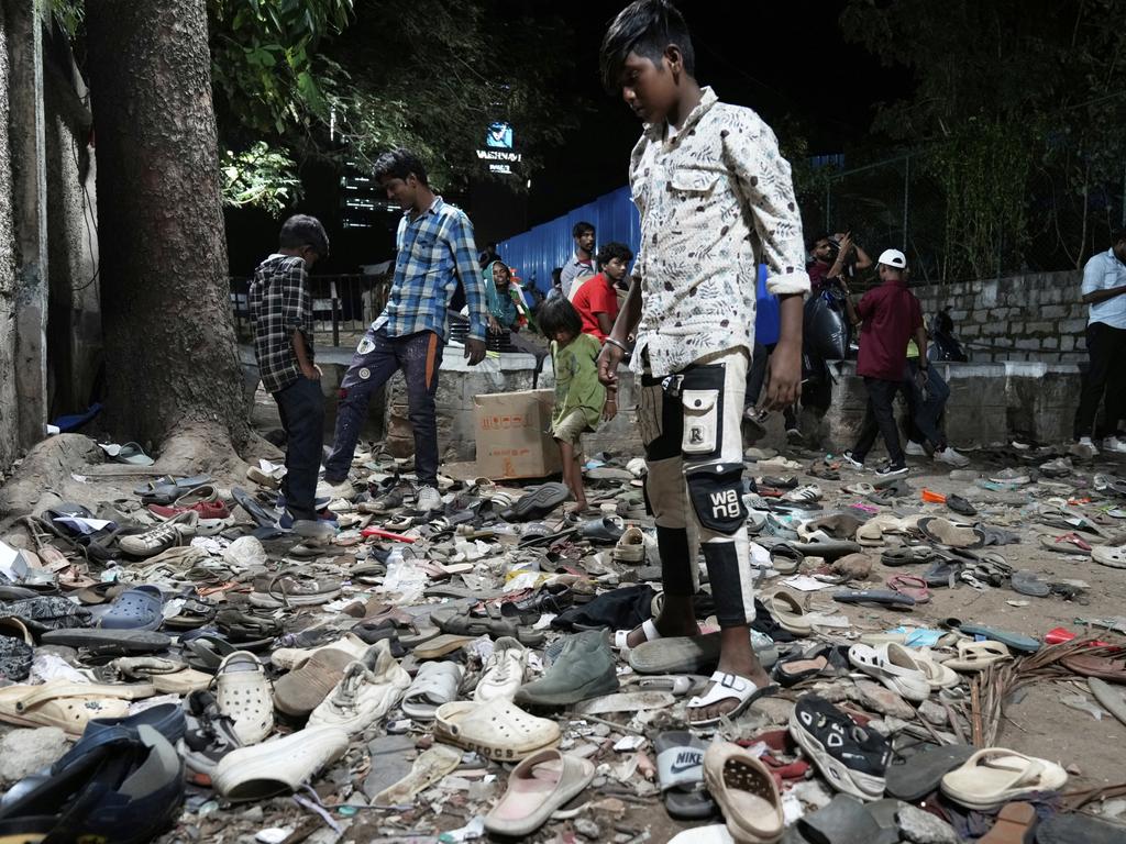People rummage through footwear strewn outside M. Chinnaswamy Stadium after a stampede at Royal Challengers Bengaluru's victory parade. Picture: AP Photo/Aijaz Rahi