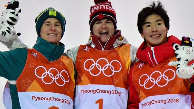 (L-R) Australia's Matt Graham, Canada's Mikael Kingsbury and Japan's Daichi Hara celebrate on the podium during the victory ceremony after the men's moguls final. Picture: AFP