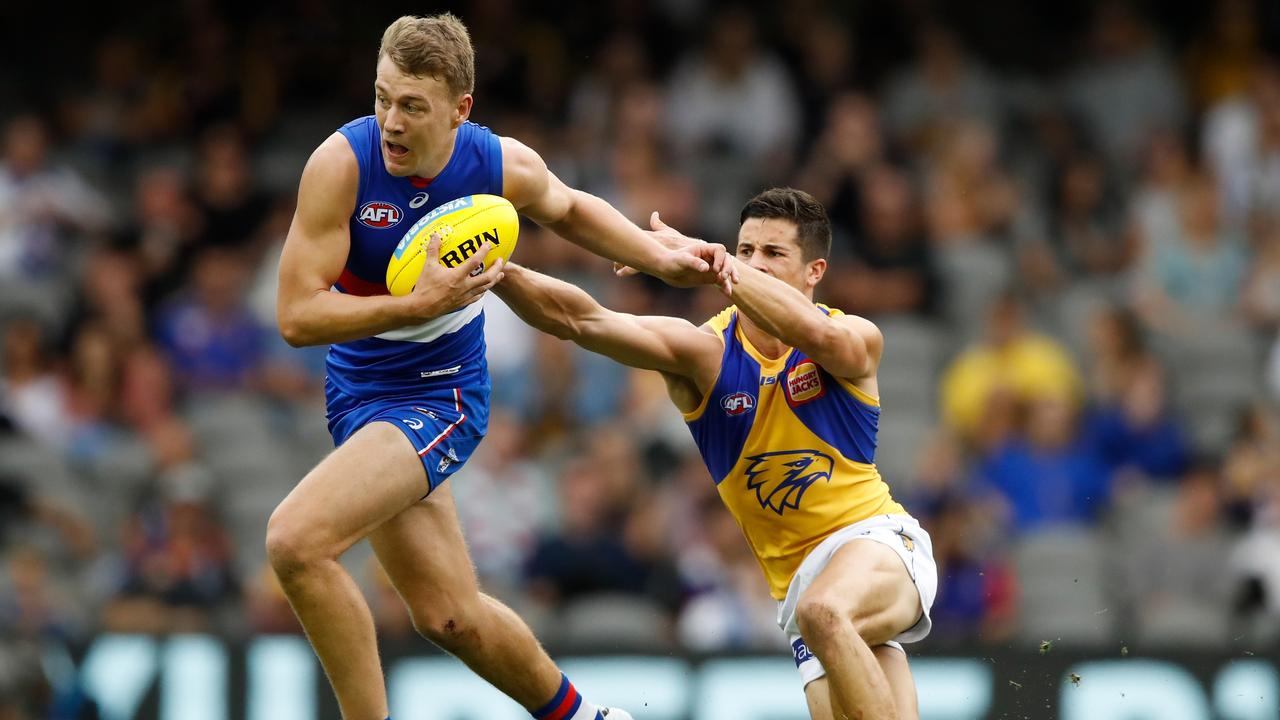 MELBOURNE, AUSTRALIA - APRIL 1: Jack Macrae of the Bulldogs and Liam Duggan of the Eagles compete for the ball during the 2018 AFL round 02 match between the Western Bulldogs and the West Coast Eagles at Etihad Stadium on April 1, 2018 in Melbourne, Australia. (Photo by Adam Trafford/AFL Media/Getty Images)