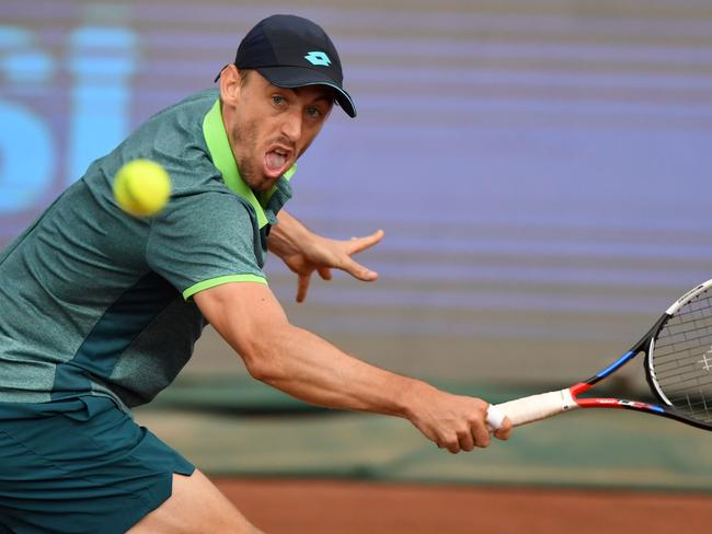 Australian John Millman returns the ball to Italian Marco Cecchinato during their ATP final tennis match at the Hungarian Open in Budapest, on April 29, 2018.  / AFP PHOTO / ATTILA KISBENEDEK