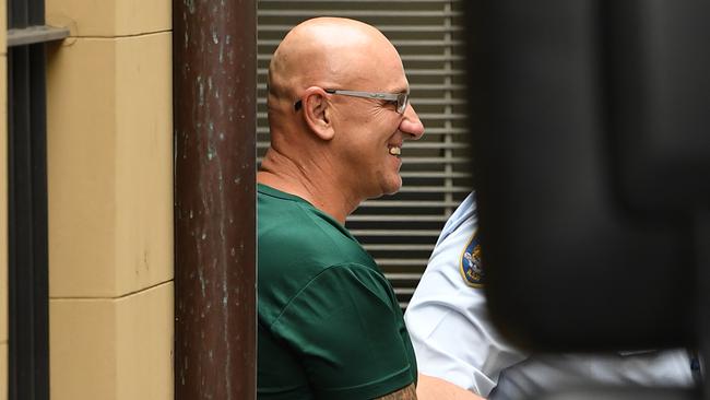 Michael Basanovic is escorted to a prison van at the NSW Supreme Court after having his murder charges downgraded. Picture: AAP/Joel Carrett