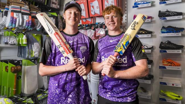 Lachlan McCarthy and Jack Connah with their Hobart Hurricanes merchandise at Intersport Hobart. Picture: Caroline Tan