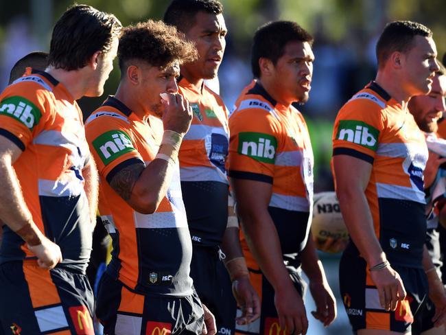 Knights' players look on following a try scored by Jason Nightingale.