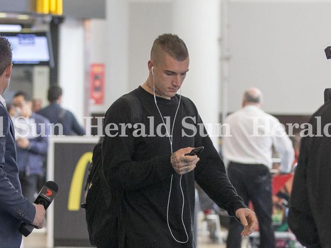 Dustin Martin arrives at Auckland Airport with his manager today