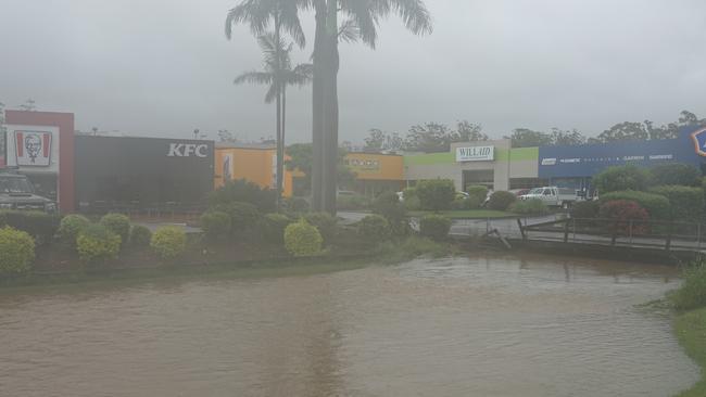 FLASHBACK: The large drain near KFC at South Coffs Harbour was awash and edging toward the Pacific Highway after torrential rain in late February 2022. Picture: Chris Knight