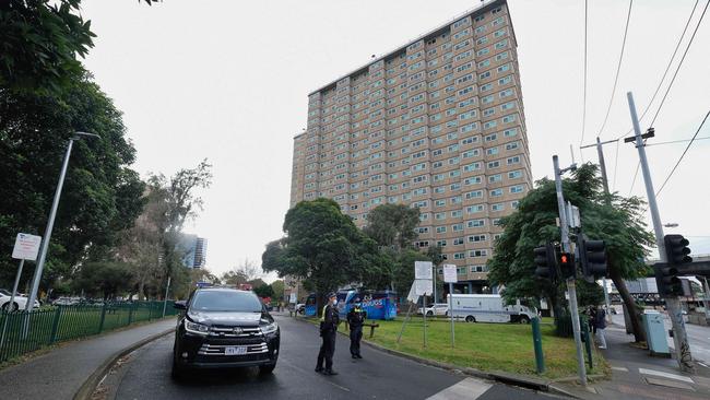 Police man the entrance of one of the nine Flemington twoers on Sunday. Picture: Luis Enrique Ascui