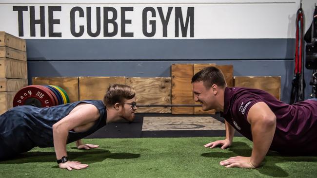 Mark Jenson and Sea Eagles Sean Keppie square off doing push-ups during their training session. Picture: Monique Harmer.