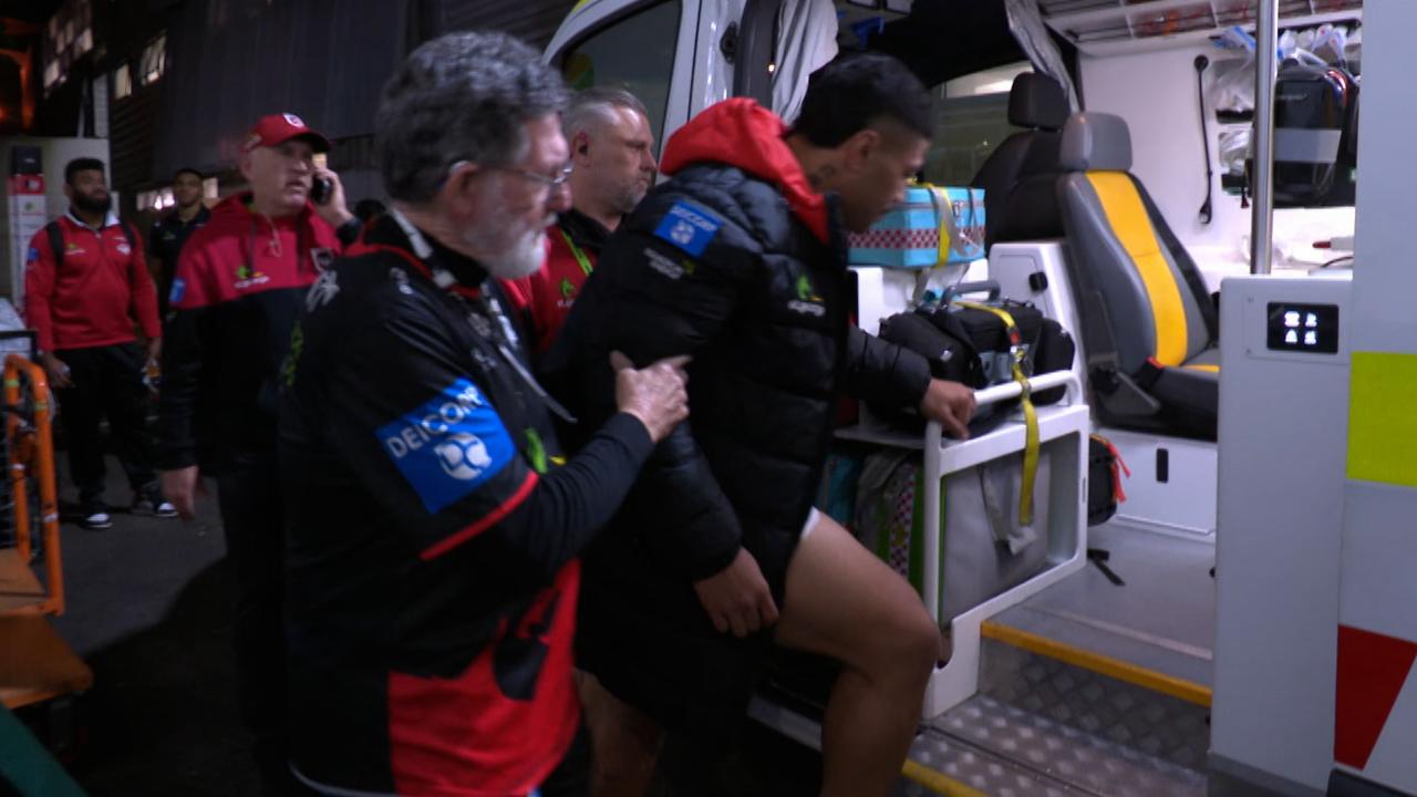 Hame Sele is helped into an ambulance.