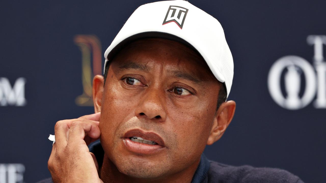 ST ANDREWS, SCOTLAND - JULY 12: Tiger Woods of The United States looks on as they are interviewed during a practice round prior to The 150th Open at St Andrews Old Course on July 12, 2022 in St Andrews, Scotland. (Photo by Harry How/Getty Images)
