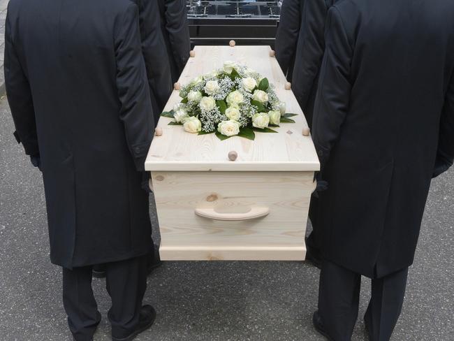 Bearers carrying a coffin into a car.  Death and funerals.  Picture: iStock