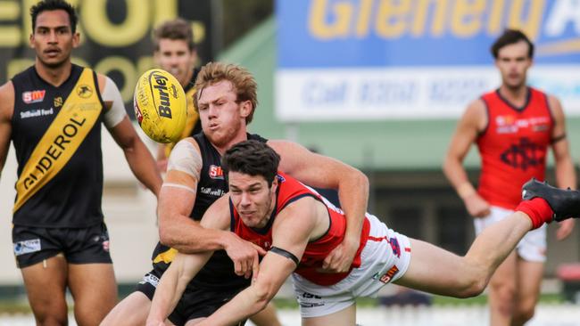 Glenelg’s Josh Scott brings down Norwood’s Ben Jefferies. Picture: Russell Millard/AAP