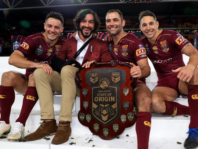 Cooper Cronk, Johnathan Thurston, Cameron Smith and Billy Slater hold the shield up to celebrate winning the Origin decider between Queensland and NSW at Suncorp Stadium in Brisbane. Pics Adam Head