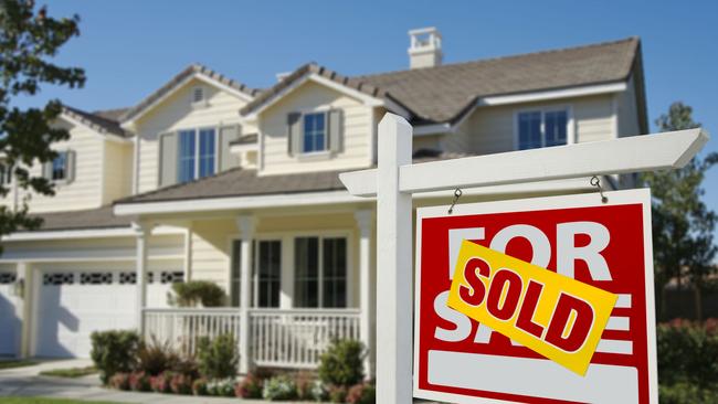 Sold Home For Sale Sign in Front of Beautiful New House.