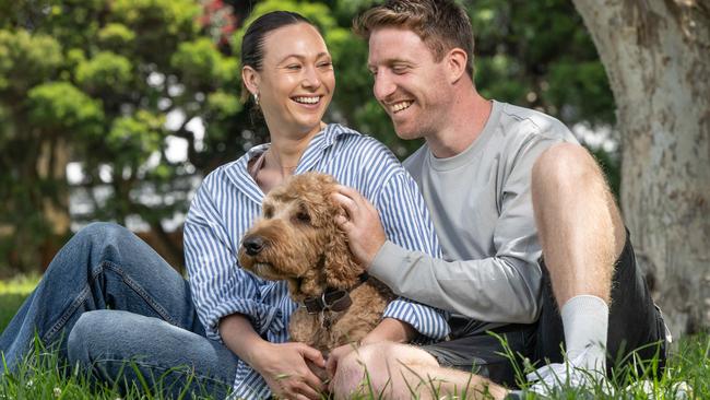 Former AFL footballer Reece Conca, 31, and partner Annabelle Grace, 29, with their dog, Albus. Picture: Brad Fleet