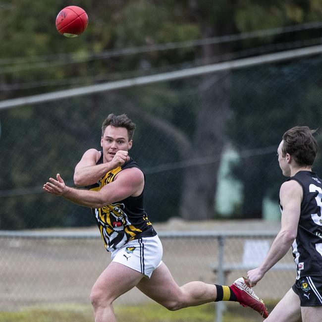 Tigers' Kieran Lovell feeds out a handball against Glenorchy. Picture: LUKE BOWDEN