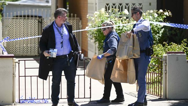 Police Major Crime officers remove bags of evidence from the scene. Picture: Mark Brake