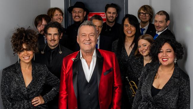 Jimmy Barnes, with his big band and singers Jade MacRae, left, and Mahalia Barnes, right. Picture: Ben Symons