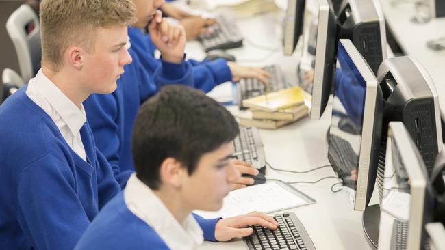 Schools of excellence - teenage students using computers in computer room.