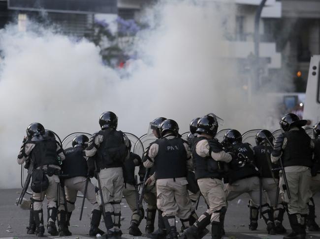 Argentina River Plate fans clash with riot police outside the Antonio Vespucio Liberti stadium prior the final soccer match of the Copa Libertadores between River Plate and Boca Juniors, in Buenos Aires, Argentina, Saturday, Nov. 24, 2018. The match has been rescheduled after the bus carrying the Boca Juniors players was attacked by River Plate fans, injuring several players. The match will be played on Sunday. (AP Photo/Sebastian Pani)