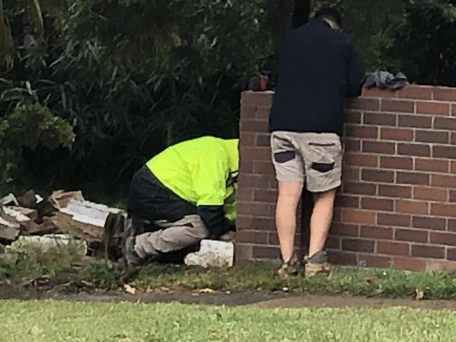 Plumbers work to repair pipes after Balgowlah solicitor John Domenic Lee crashed his Jaguar 4WD through a garden wall while he was drink driving. Picture: Jim O'Rourke