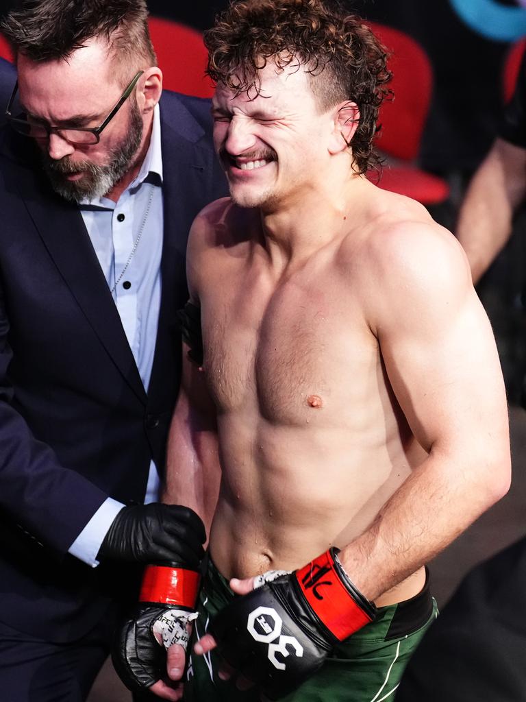 Jenkins leaves the cage in agony. Picture: Chris Unger/Zuffa LLC/Getty Images