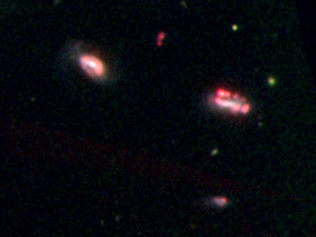 This photo released on January 23 by the Nature Publishing Group shows an optical image of one of the isolated galaxy groups observed with the Magellan Telescope in Chile. The red knots reveal emissions that signify recent and ongoing star formation. Picture: Kelsey E Johnson, Sandra E Liss, and Sabrina Stierwalt.