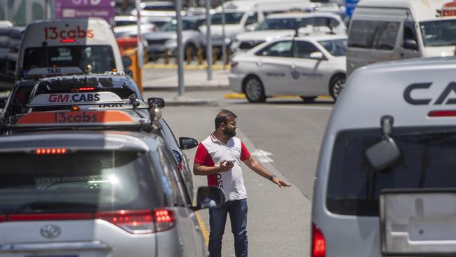 Passengers at Sydney International Airport are funnelled in the queue at the taxi rank to the first available car. Photo Jeremy Piper