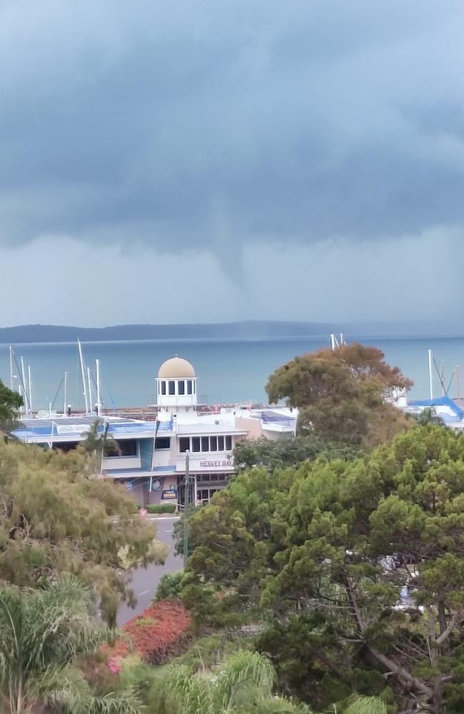 The waterspout pictured in the distance with the Hervey Bay Boat Club in the foreground. Picture: Bec Marks