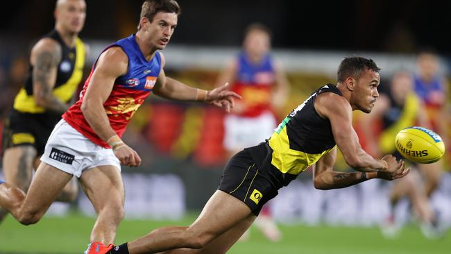 Sydney Stack gets a handball away for the Tigers at Metricon Stadium Picture: Michael Klein