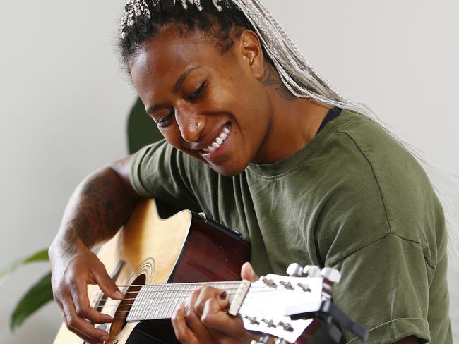 Rugby Sevens Player Ellia Green playing guitar at her home.  Picture: John Appleyard