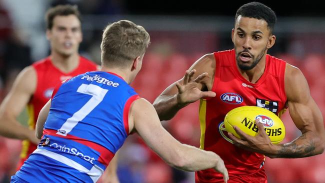 Touk Miller looks to evade a tackle during another monster game for the Suns. Picture: FL Photos via Getty Images