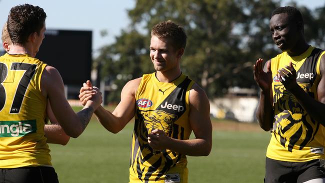 Richmond players congratulate Dan Butler on his upcoming debut. Picture: Wayne Ludbey