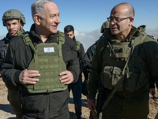 This handout picture released by the Government Press Office (GPO) shows Israeli Prime Minister Benjamin Netanyahu (L) walking among members of the Israeli army at Mount Hermon in the annexed Golan Heights, on December 17, 2024. Netanyahu held a security briefing on December 17, atop a strategic Syrian mountain inside the UN-patrolled buffer zone on the Golan Heights that Israel seized this month, the defence minister said. (Photo by GPO / AFP) / Israel OUT / XGTY / === RESTRICTED TO EDITORIAL USE - MANDATORY CREDIT "AFP PHOTO / Handout /GPO' - NO MARKETING NO ADVERTISING CAMPAIGNS - DISTRIBUTED AS A SERVICE TO CLIENTS ==