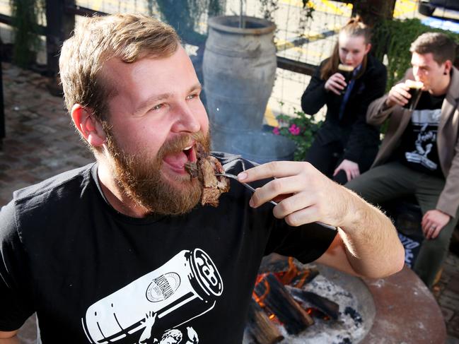 L-R David Ward, Jordan Richards and Paul Fear have Brisket and craft beer around a fire pit at the Australian Hotel & Brewery. Rouse Hill, Friday, June 15th 2018. Australian Hotel & Brewery are holding a craft beer night that is winter/Game of Thrones themed. (AAP Image / Angelo Velardo)