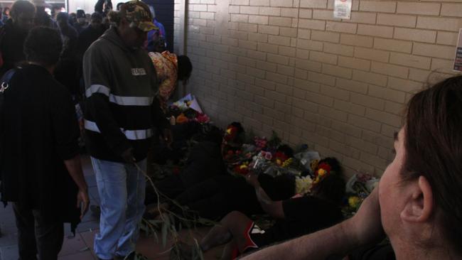 Family grieve for their 24-year-old family member at a vigil outside Coles in Alice Springs on May 30, 2025. The young man died in custody on May 27, 2025. Picture: Gera Kazkov
