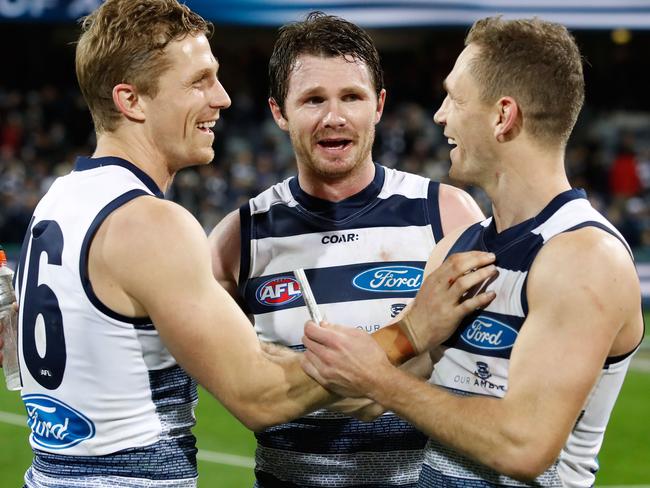 Joel Selwood celebrates with brother Scott Selwood and Patrick Dangerfield. Picture: Adam Trafford/AFL Media/Getty Images