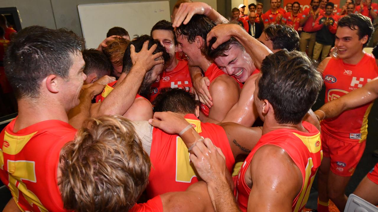 The Suns players celebrate winning the AFL Round 2 match between the Gold Coast Suns and the Fremantle Dockers at Metricon Stadium last season.