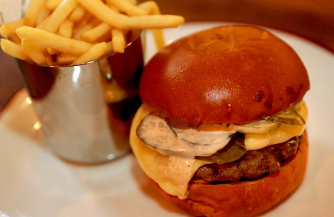 Chophouse’s cheeseburger ($23) is served with dry-aged beef and melted raclette.