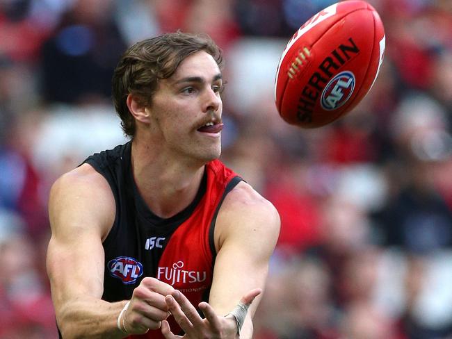 Joe Daniher of the Bombers handballs during the Round 7 AFL match between the Essendon Bombers and the Hawthorn Hawks at the MCG in Melbourne, Saturday, May 5, 2018. (AAP Image/Hamish Blair) NO ARCHIVING, EDITORIAL USE ONLY