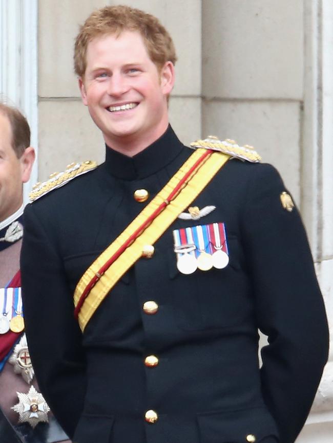 Prince Harry enjoys a joke on the balcony during Trooping the Colour in 2014. Picture: Chris Jackson/Getty Images