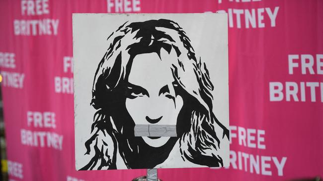 A woman holds a poster of Britney with her mouth taped shut as fans and supporters gather outside the Los Angeles County Courthouse in Los Angeles on July 14. Picture: AFP