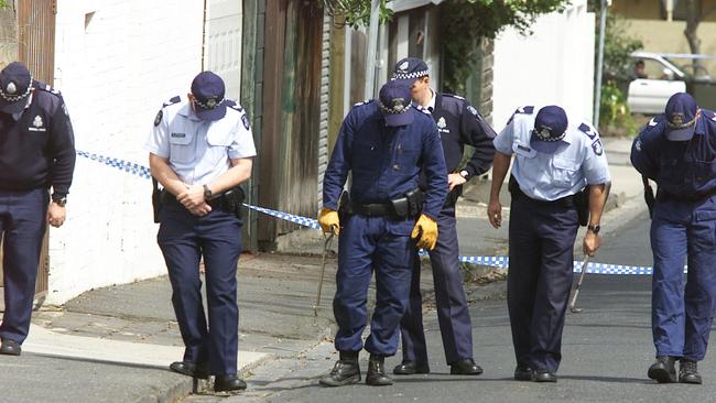 Police look for evidence at the scene of the shooting of Michael Marshall in South Yarra.