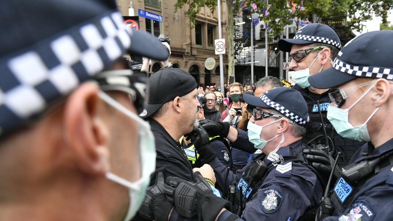 Protesters congregate at Flinders Street Station to rally against Australia Day